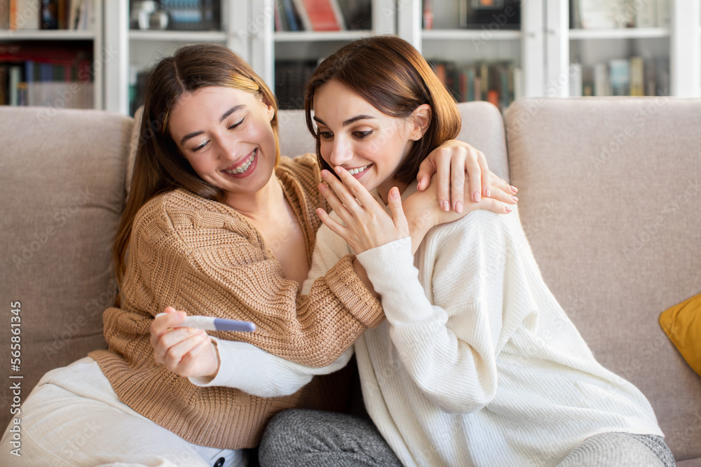 Cheerful european millennial lady hugs and congratulate surprised happy girlfriend with pregnancy Cheerful european millennial lady hugs and congratulate surprised happy girlfriend with pregnancy