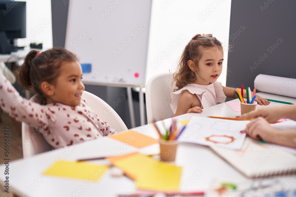 Two kids preschool students having lesson with teacher at classroom Two kids preschool students having lesson with teacher at classroom