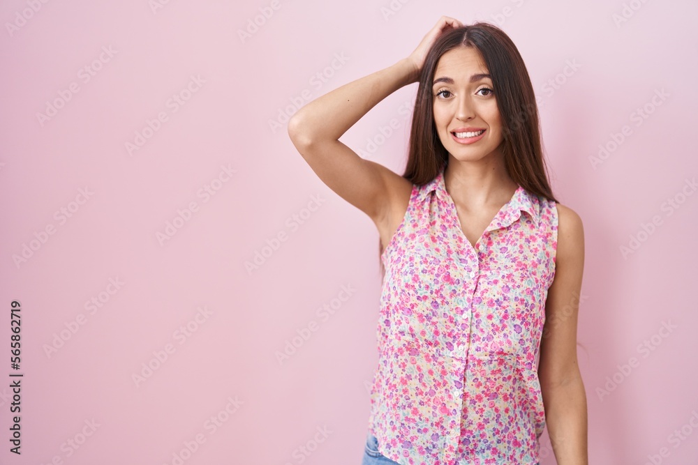 Young hispanic woman with long hair standing over pink background confuse and wonder about question. uncertain with doubt, thinking with hand on head. pensive concept. Young hispanic woman with long hair standing over pink background confuse and wonder about question. uncertain with doubt, thinking with hand on head. pensive concept.