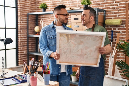 Two men artists smiling confident looking draw at art studio