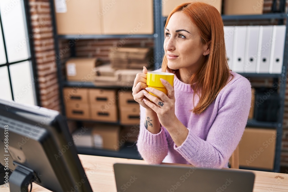 Young caucasian woman ecommerce business worker drinking coffee at office Young caucasian woman ecommerce business worker drinking coffee at office