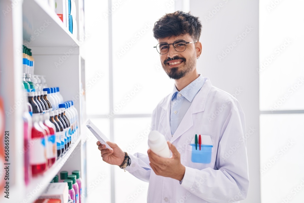 Young hispanic man pharmacist holding pills bottle reading preascription at pharmacy Young hispanic man pharmacist holding pills bottle reading preascription at pharmacy
