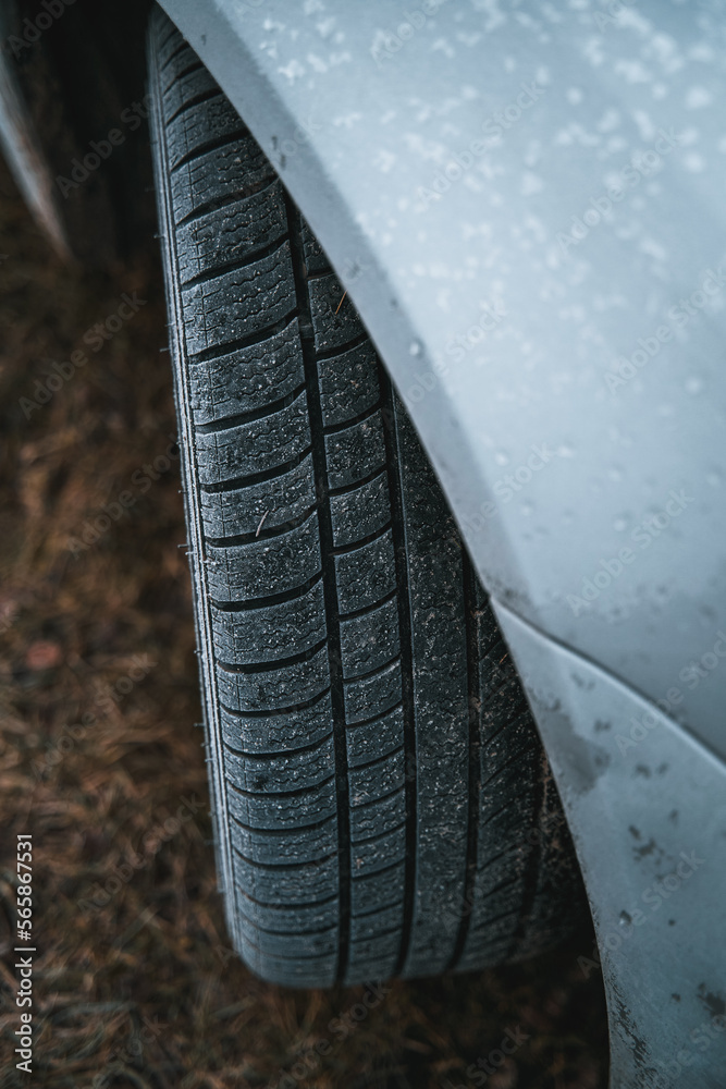 Close-up of car wheels rubber tires in winter snow. Concept of transportation and safety during the winter season. Selective focus.