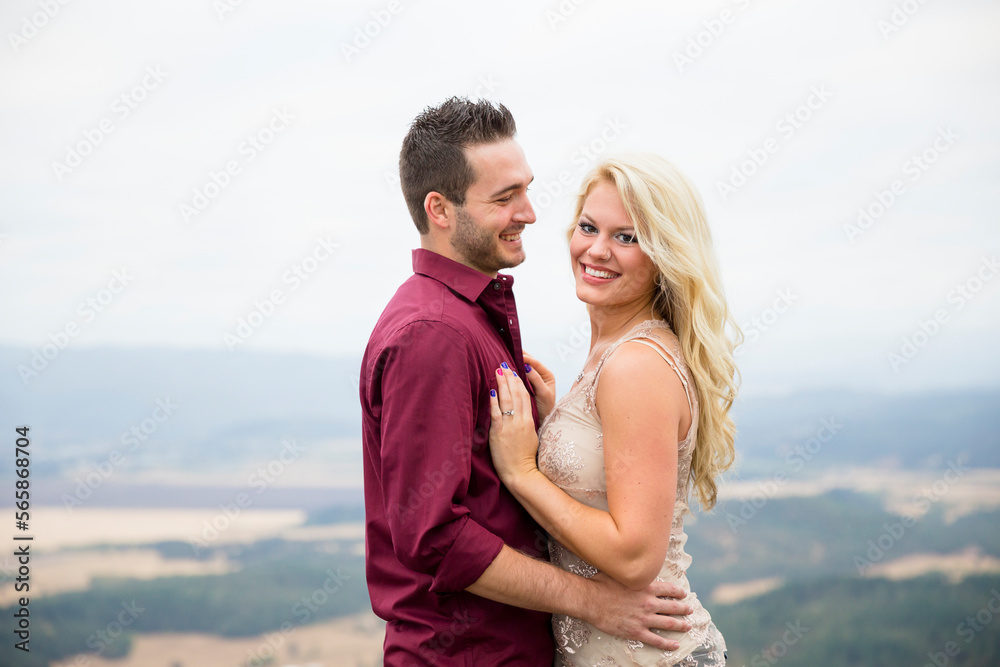 Portrait of engaged couple smiling and looking at camera, Eugene, Oregon, USA Portrait of engaged couple smiling and looking at camera, Eugene, Oregon, USA