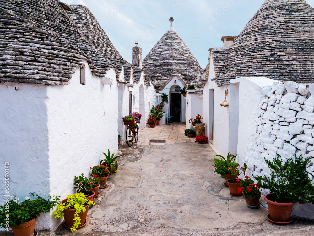 Typical alley of the village of Alberobello with traditional trulli houses, Apulia region, southern Italy
