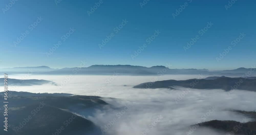 Aerial View. Flying over the high mountains in beautiful clouds. Aerial Drone camera shot. Air pollution clouds over Sarajevo in Bosnia and Herzegovina. Aerial View. Flying over the high mountains in beautiful clouds. Aerial Drone camera shot. Air pollution clouds over Sarajevo in Bosnia and Herzegovina.