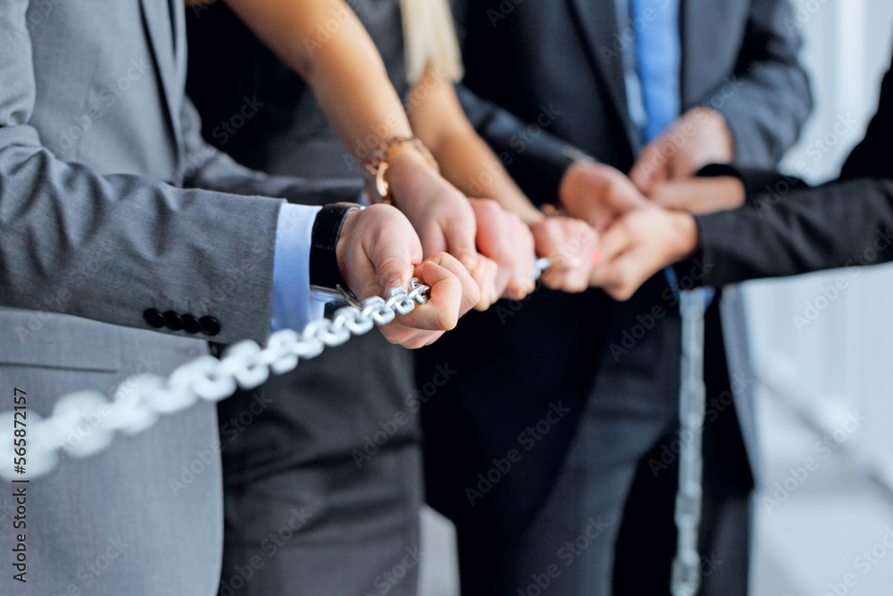 Business people pulling chain Business people pulling chain