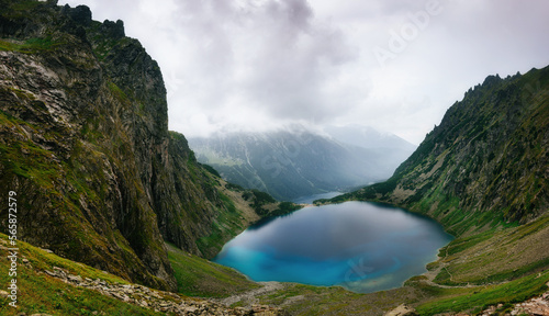Panorama Famous Mountains Lake Morskie Oko Or Sea Eye Lake In fog. Five Lakes Valley. Beautiful Scenic View. Tatra National Park, Poland. UNESCO's World Network of Biosphere Reserves.