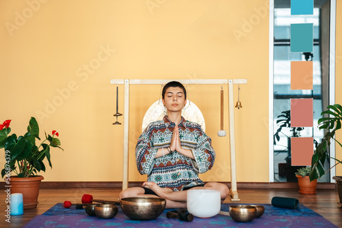 Portarait The girl is meditating Tibetan singing bowl in sound therapy photo