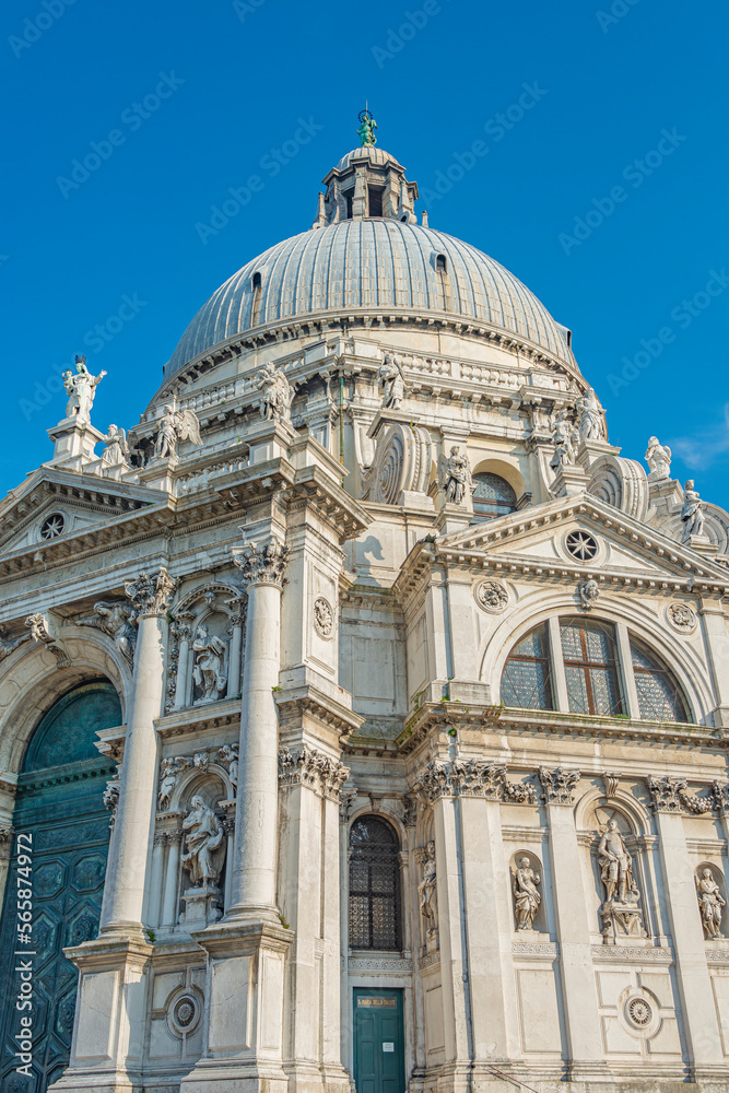 Cover page over Grand Canal with Basilica di Santa Maria della Salute, in Venice historical downtown, Italy, at sunny day, blue sky