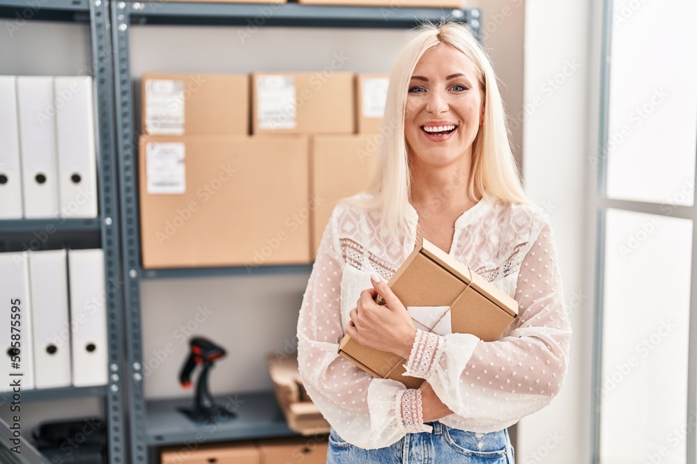 Caucasian woman working at small business ecommerce smiling and laughing hard out loud because funny crazy joke. Caucasian woman working at small business ecommerce smiling and laughing hard out loud because funny crazy joke.