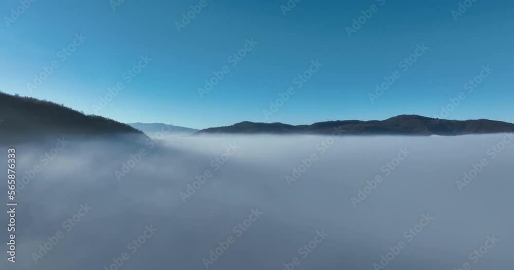 Aerial View. Flying over the high mountains in beautiful clouds. Aerial Drone camera shot. Air pollution clouds over Sarajevo in Bosnia and Herzegovina. Aerial View. Flying over the high mountains in beautiful clouds. Aerial Drone camera shot. Air pollution clouds over Sarajevo in Bosnia and Herzegovina.