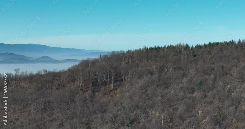Aerial View. Flying over the high mountains in beautiful clouds. Aerial Drone camera shot. Air pollution clouds over Sarajevo in Bosnia and Herzegovina. Aerial View. Flying over the high mountains in beautiful clouds. Aerial Drone camera shot. Air pollution clouds over Sarajevo in Bosnia and Herzegovina.