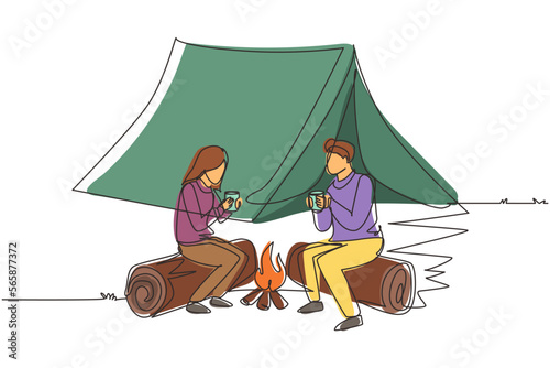 Single one line drawing couple near bonfire, romantic date out of town, camping. Man and woman getting warm near campfire and drinking tea sitting on logs in forest. Continuous line draw design vector