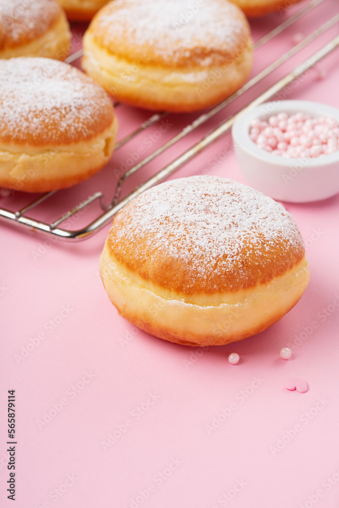 Donuts Doughnuts with Icing Sugar and Sprinkles on Pink Background