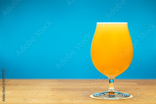 Full tulip glass of NEIPA beer on a table photo