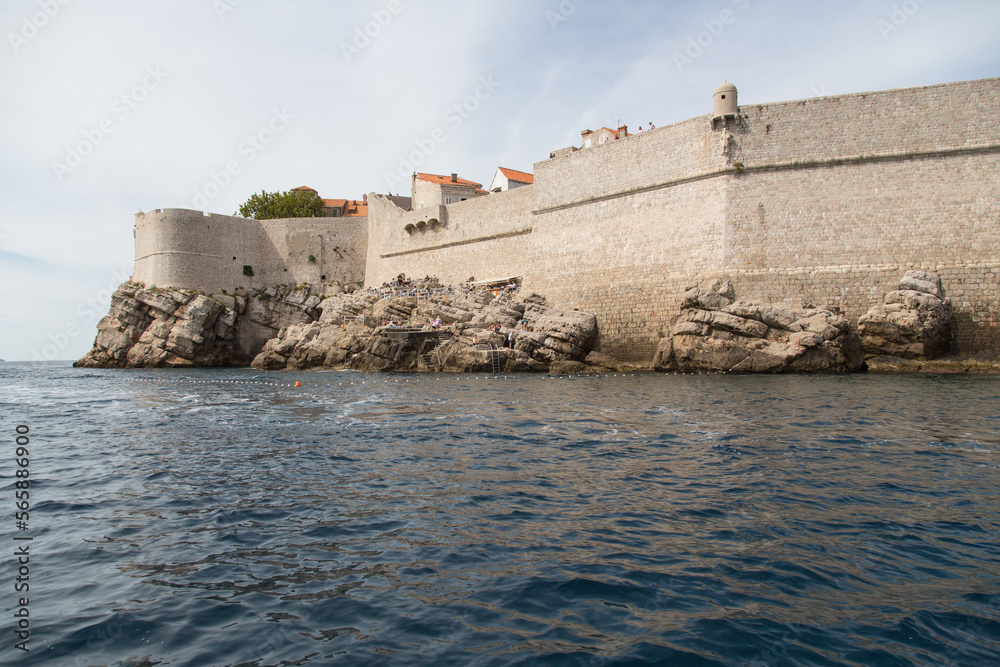 Seaside view of the outstanding impressive walls  surrounding the old town of Dubrovnik, Croatia - one of the best preserved fortification systems in Europe