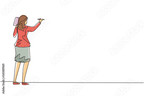 Single continuous line drawing business school professor teaching explaining and writing formula on chalkboard. Young business woman teacher standing at class. One line draw design vector illustration
