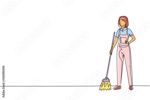 Single continuous line drawing smiling young woman janitor standing in uniform, sweeping the floor with broom, professional cleaning, home and office service. One line draw design vector illustration