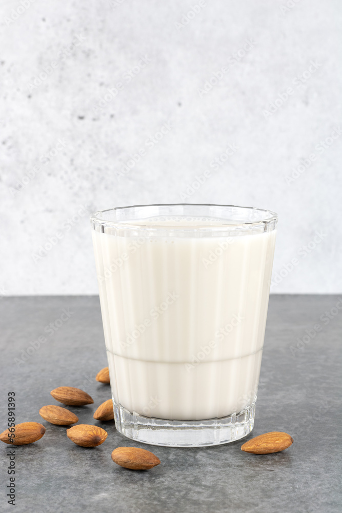 Almond milk with almonds on a gray background. Selective focus. Copy Space. Almond milk with almonds on a gray background. Selective focus. Copy Space.