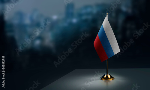 Small flags of the Russia on an abstract blurry background