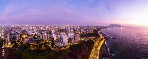 Miraflores/Lima/Peru after sunset drone panorama of skyline showing traffic at armendariz photo