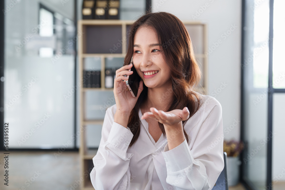 Beautiful asian business woman with smartphone in office. Woman in casual at office Beautiful asian business woman with smartphone in office. Woman in casual at office