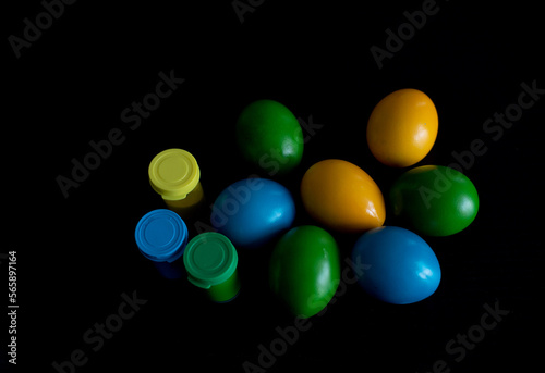 Easter eggs in nest painted by hand in blue color on dark background. Chicken and quail eggs catholic and orthodox easter holiday