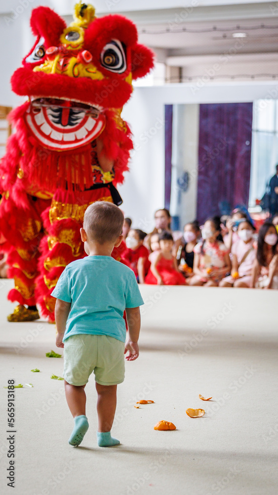 Child facing Nian the Chinese New Year Lion