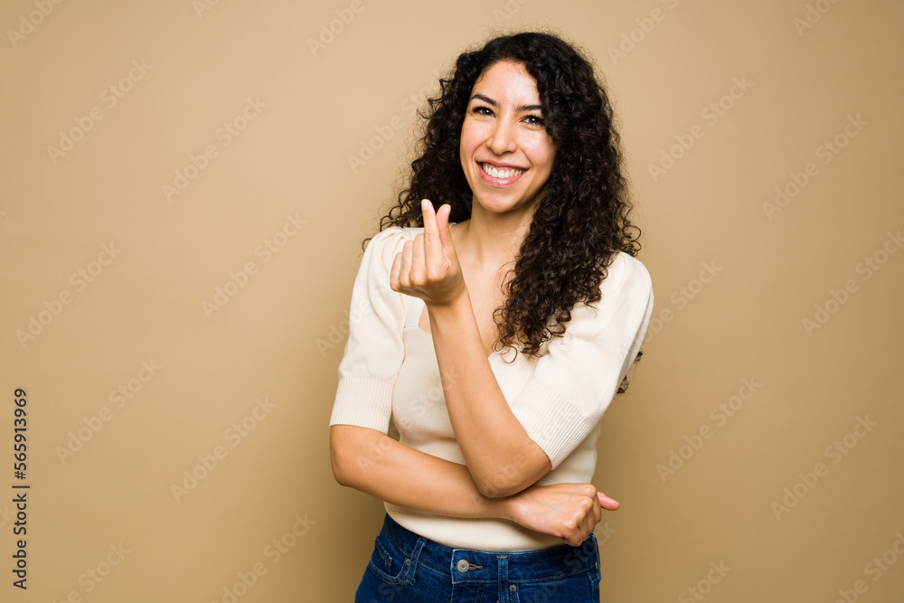 Beautiful young woman showing a korean heart Beautiful young woman showing a korean heart