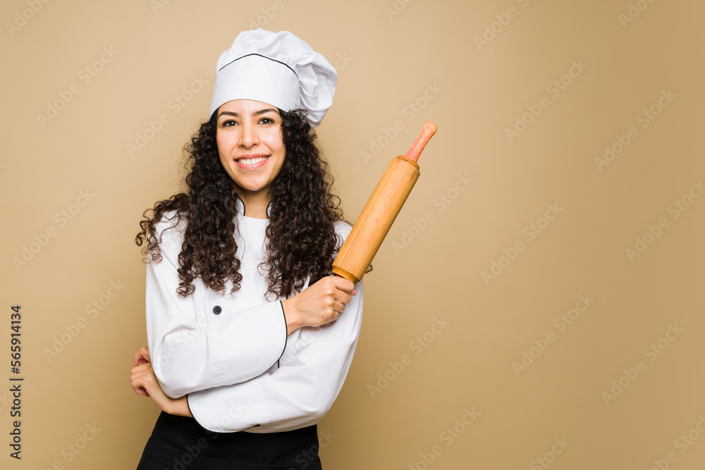 Beautiful chef cooking or baking with a rolling pin Beautiful chef cooking or baking with a rolling pin