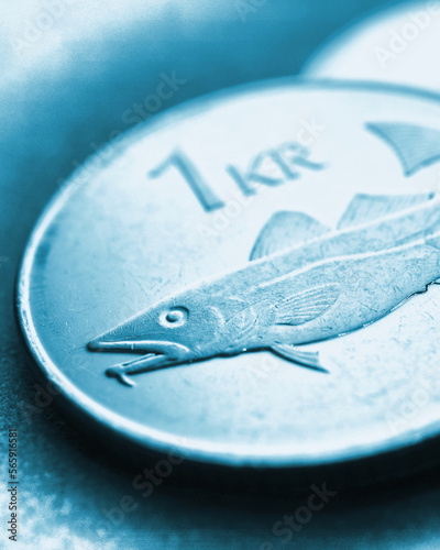 Icelandic 1 one crona coin closeup. National currency of Iceland. Light blue tinted vertical stories for news about economy or money. Loan and credit. Crown and central bank of Iceland. Macro