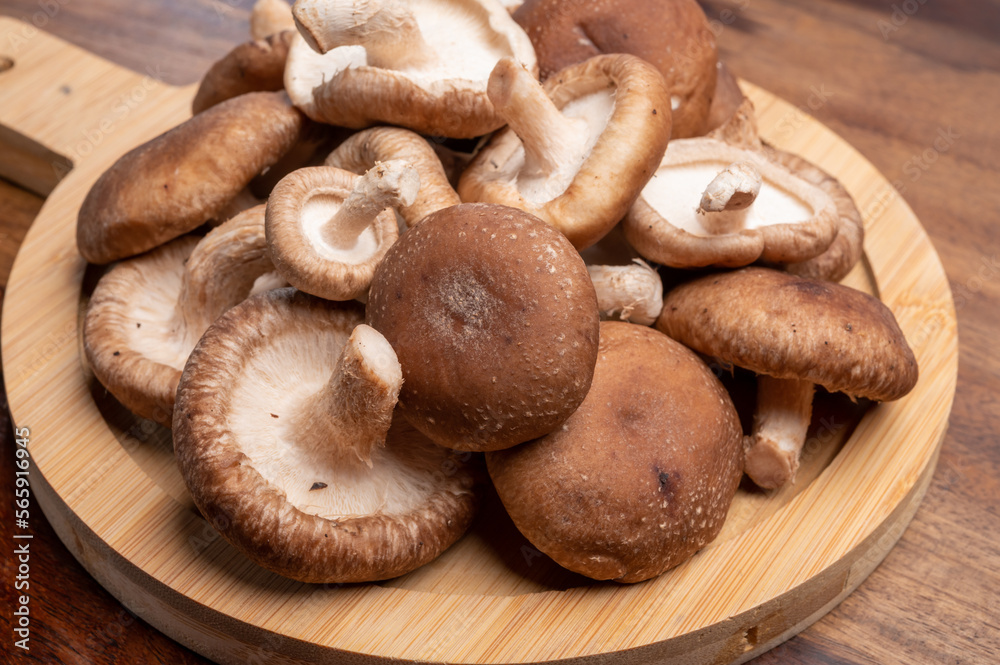 Fresh brown Lentinula edodes or shiitake edible mushrooms Fresh brown Lentinula edodes or shiitake edible mushrooms
