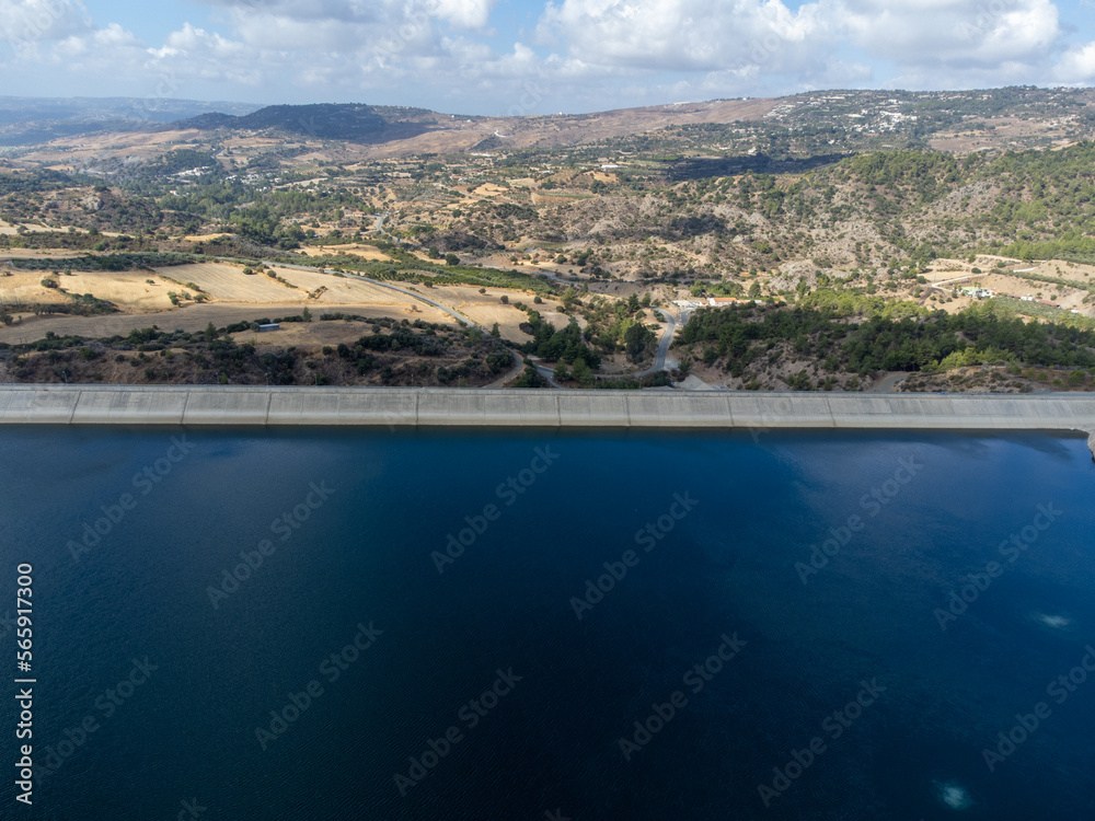 Aerial view on freshwater lake with dam for irrigation and drinking in centre of dry, sunny Cyprus island