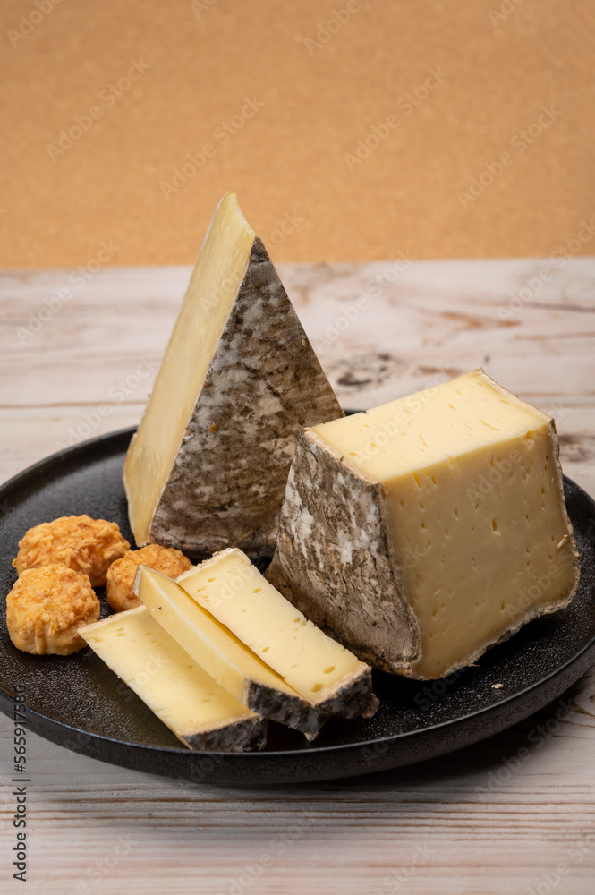 Pieces of cheese tomme de montagne or tomme de savoie made from cow milk in French Alps