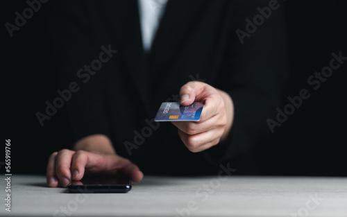 Online payment, human hand holding credit card and using smartphone for online shopping.