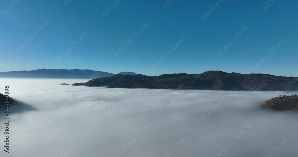 Aerial View. Flying over the high mountains in beautiful clouds. Aerial Drone camera shot. Air pollution clouds over Sarajevo in Bosnia and Herzegovina. Aerial View. Flying over the high mountains in beautiful clouds. Aerial Drone camera shot. Air pollution clouds over Sarajevo in Bosnia and Herzegovina.