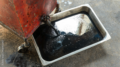 Old oil tray that was removed from the automobile. Old black oil lubrication engine vehicle motor car used leak or drip spill from car