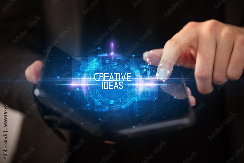 Young man holding a foldable smartphone Young man holding a foldable smartphone