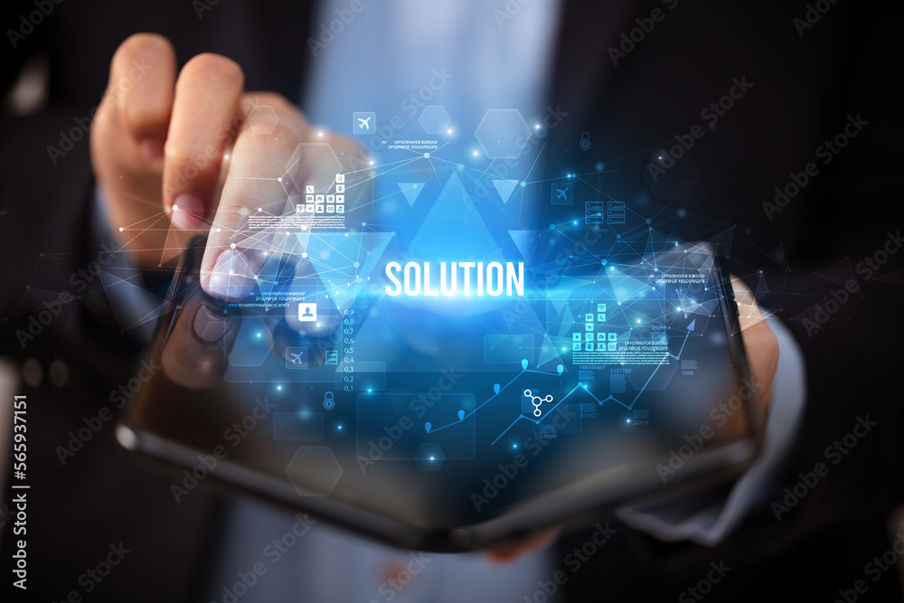 Businessman holding a foldable smartphone, business concept Businessman holding a foldable smartphone, business concept