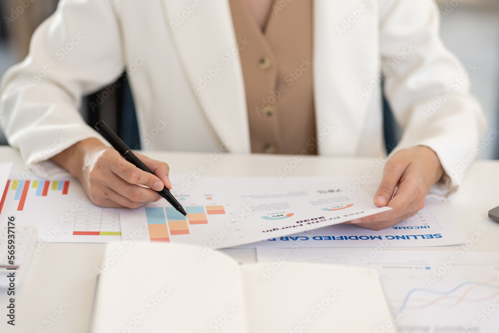 Fototapeta premium Asian Business woman using calculator and laptop for doing math finance on an office desk, tax, report, accounting, statistics, and analytical research concept 