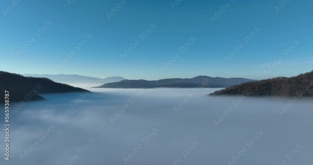 Aerial View. Flying over the high mountains in beautiful clouds. Aerial Drone camera shot. Air pollution clouds over Sarajevo in Bosnia and Herzegovina. Aerial View. Flying over the high mountains in beautiful clouds. Aerial Drone camera shot. Air pollution clouds over Sarajevo in Bosnia and Herzegovina.
