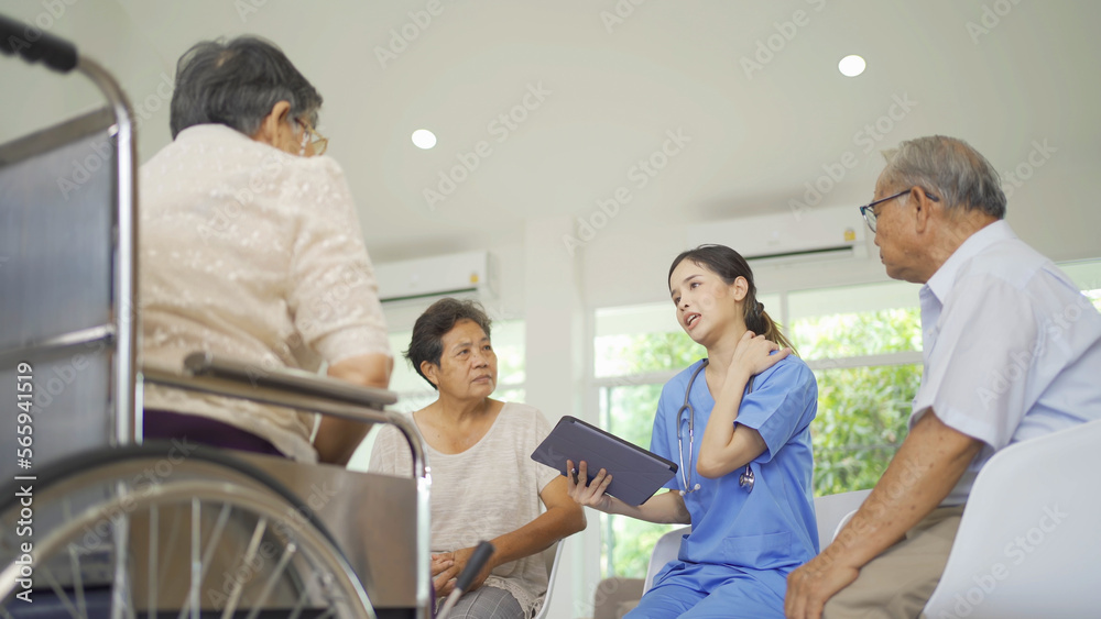An Asian nurse talking to a group of old elderly patient or pensioner people smiling, relaxing, having fun together in nursing home. Senior lifestyle activity recreation. Retirement. Health care An Asian nurse talking to a group of old elderly patient or pensioner people smiling, relaxing, having fun together in nursing home. Senior lifestyle activity recreation. Retirement. Health care