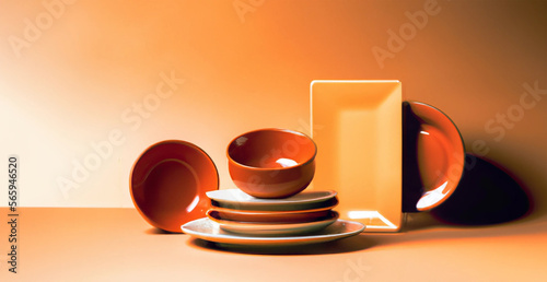illustrazione creata con intelligenza artificiale di ceramiche sui toni dell' arancione, piatti, tazze, fondine , luci di studio, ordine gradevole photo