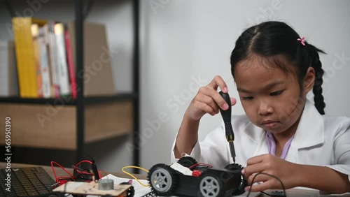 Wallpaper Mural Asian littlle girl constructing and coding robot at STEM class,Fixing and repair mechanic toy car Torontodigital.ca