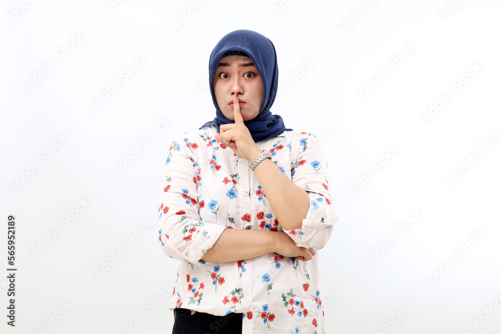 Asian muslim woman standing with silence hand gesture. Isolated on white background Asian muslim woman standing with silence hand gesture. Isolated on white background