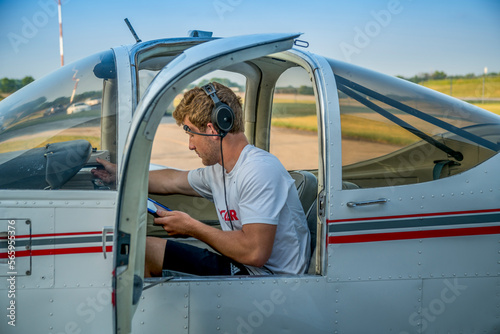 Teenage boy preparing to fly small airplane photo