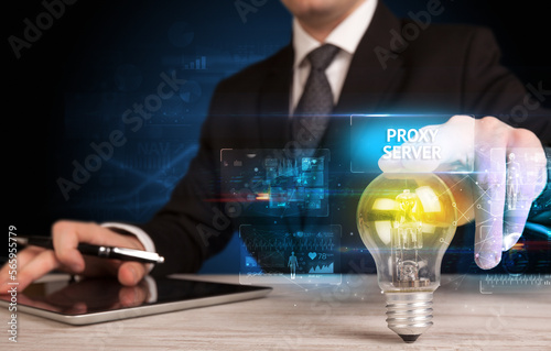 Businessman holding a light bulb, online security concept photo