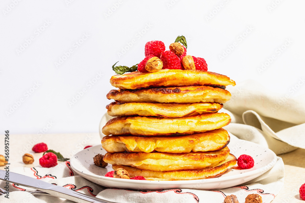 Classic homemade American pancakes with frozen raspberries, hazelnut and mint. Healthy breakfast Classic homemade American pancakes with frozen raspberries, hazelnut and mint. Healthy breakfast