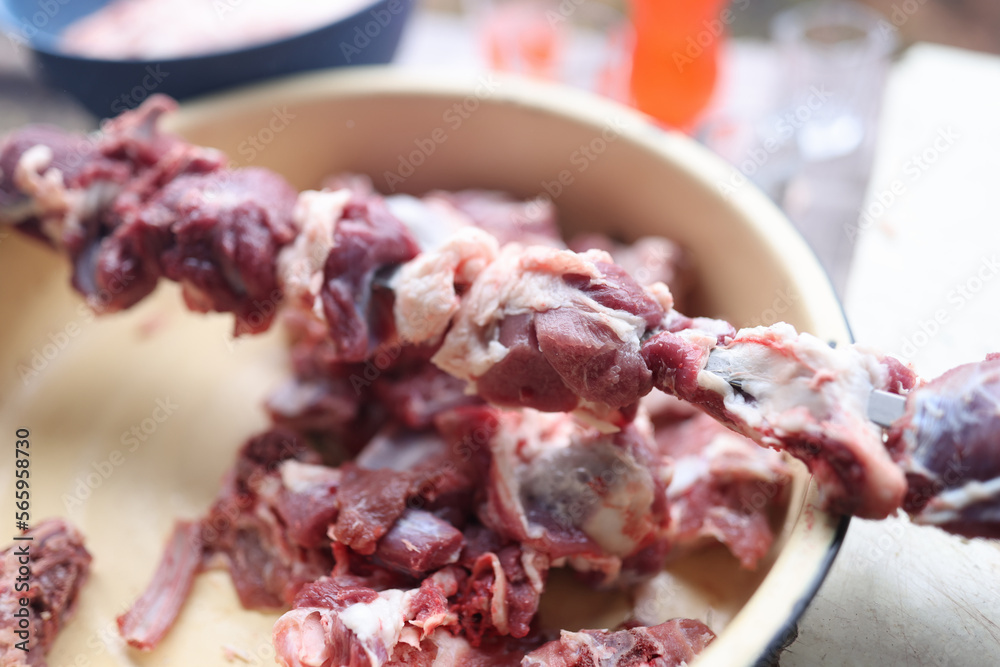 Preparing raw meat for barbecue close-up.